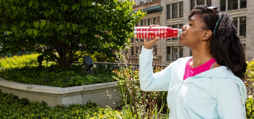 Woman drinking out of Kellogg's Special K promotional water bottle